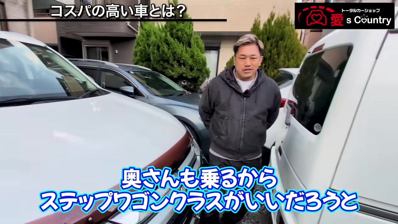 アルファードの前で車選びを説明するスタッフ